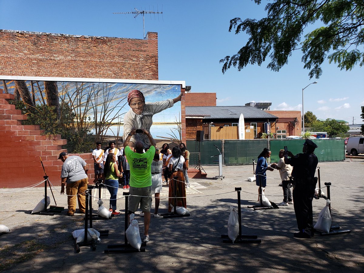 MuralTubman's tweet photo. Preparation underway for the #HarrietTubmanMural ribbon cutting at 1pm.  Lots of excitement in the air. Art, vendors, food,  and a beautiful day! #TakeMyHand #DayofResilience #CambridgeMD https://t.co/eIxT4qCnQJ
