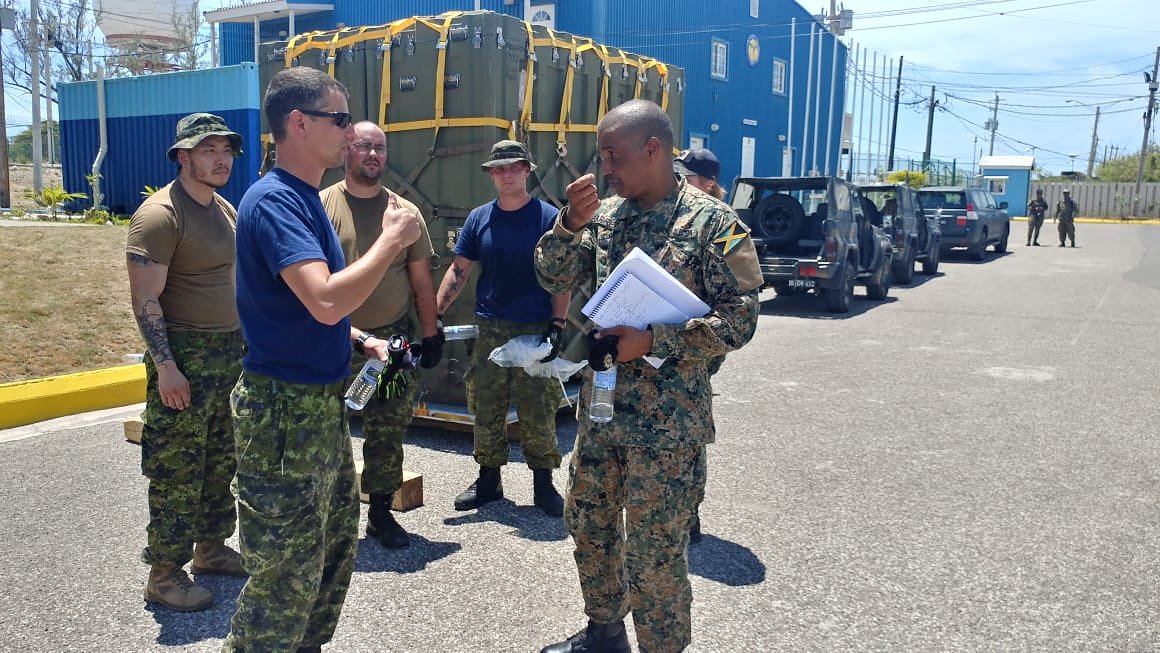 JDFSoldier's tweet image. Captain Kyle Ferguson of the Royal Canadian Air Force (second left) discusses with Captain Wayne Barrett of the Jamaica Defence Force (right), the state of preparations for the (Disaster Assistance Response Team) DART deployment to the Bahamas.