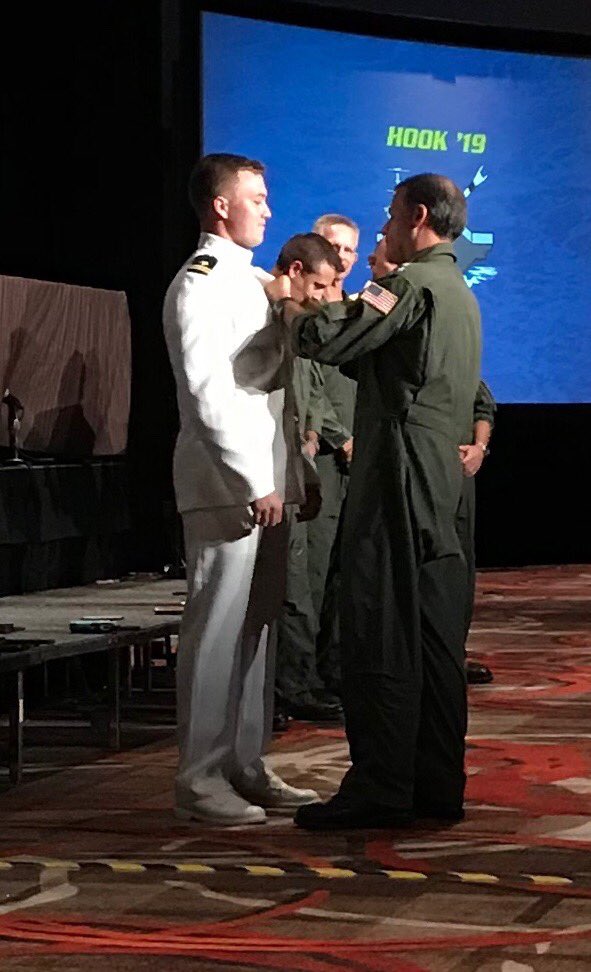 flynavy's tweet photo. Just winged at #Hook19: Per Tailhook tradition, a legend donates his wings to the newest pilot or NFO. LTJG Brett Dunlap of Winter Park, FL just received the Wings of Gold from ADM Chris “Lung” Aquilino, Commander, @USPacificFleet. Dunlap will report to VFA-106 in the fall. https://t.co/10LrHM7Q2e