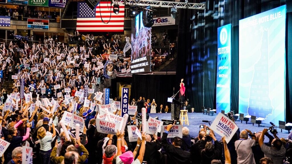 Elizabeth Warren waves at the crowd at the New Hampshire Democratic Convention.