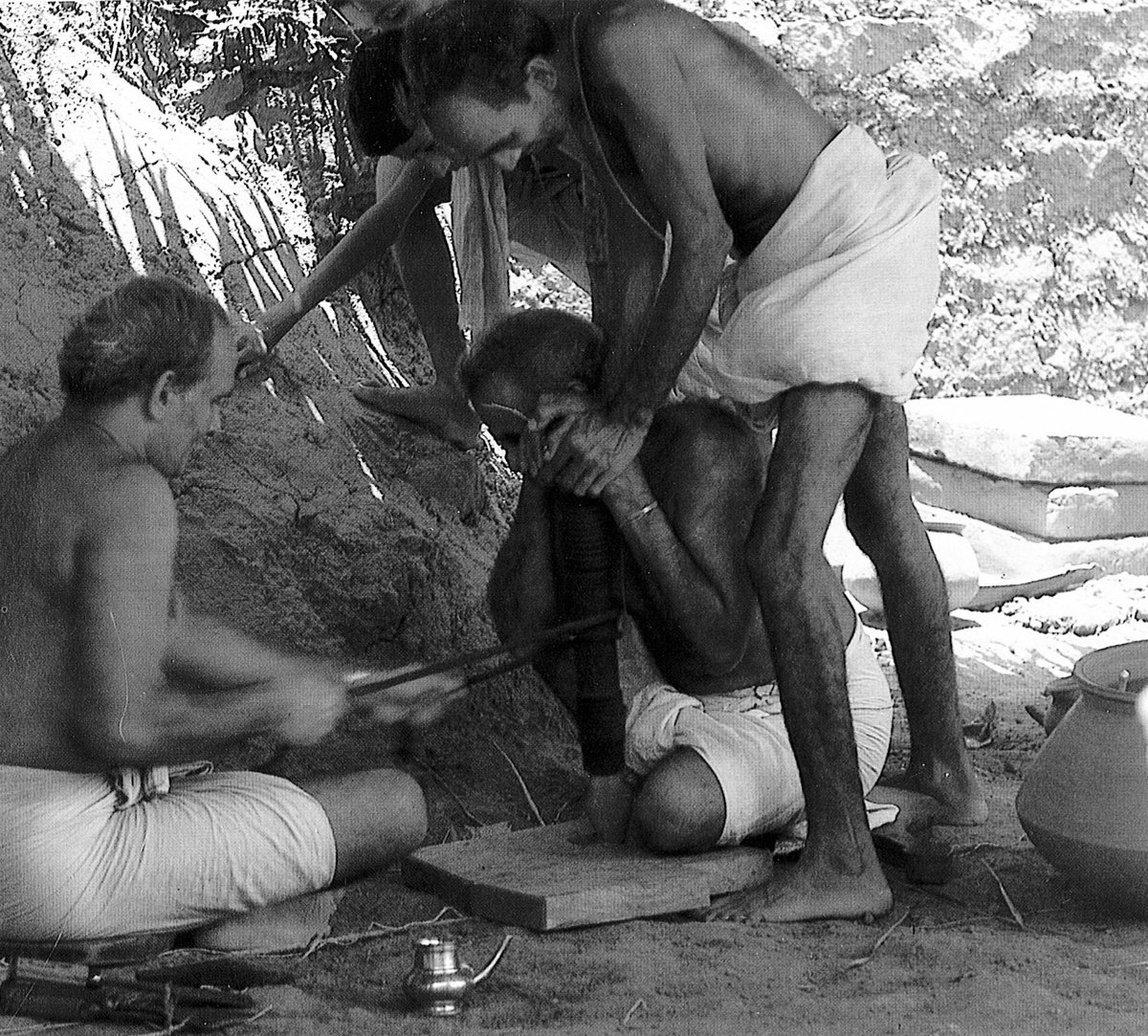 C. V. Vasudevan Akkithiripad pulls the strings that causes the churning stick (ittanthand in Malayalam) to rotate in the lower kindling wooden block (adhara-aani) to produce fire. During the 12 days of Agnicayana, the fire has to be produced 7 times.