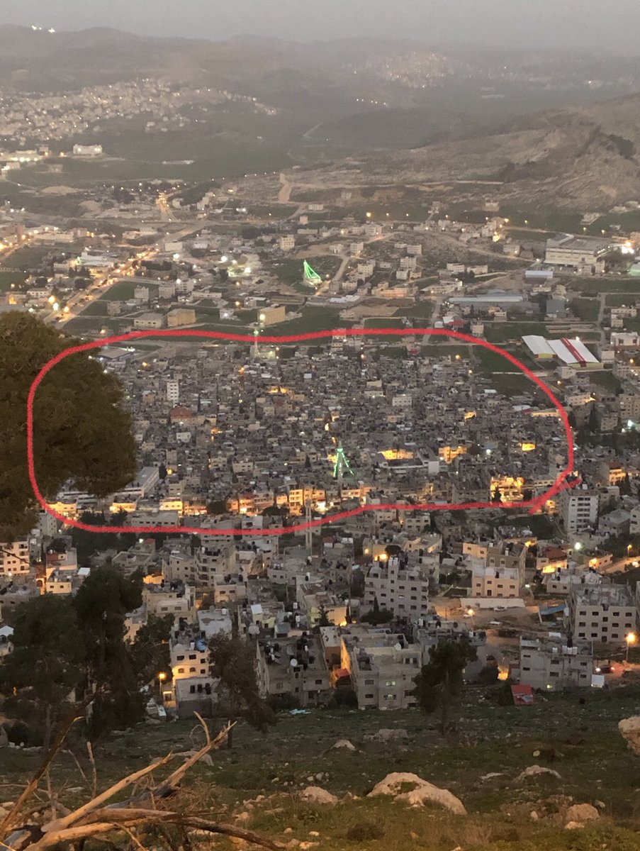 Jonathan_Elk's tweet photo. This is Balata refugee camp in Nablus, West Bank. 100% under Palestinian Authority. Street divides between the city and camp. Palestinians in camps have no rights from PA &amp; can’t even buy house in the street across. Why is there still refugees under PA if it’s their own state? https://t.co/mjt0fm5Fej