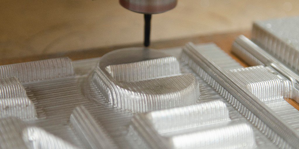 Close up photos of the CNC machining the CAD file for Planche signage out of aluminium. Each letter was then hand finished using a variety of filers and polished to produce a smooth rounded surface ready for an aged look enamel and gloss spray finish.