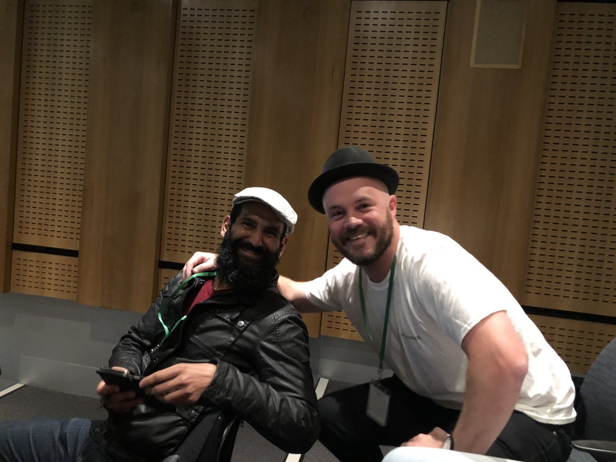 JamesFarrey's tweet photo. The coolest cats @ServerlessMEL swapping hats. #hatless #serverless #sdmel19 @LachlanBradfor1 https://t.co/zfdFj4sU2a