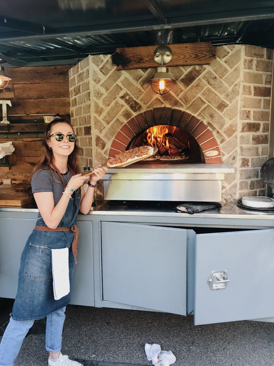 FritzKnoebel's tweet photo. This week's #whereweworkwednesday goes out to Jess, from the Class of 2020! Jess is currently interning for Mountain Crust Catering, a Fritz Alumni owned, local Denver caterer, cooking up some absolutely fire wood-fired pizzas! #FritzKnoebel #DUSummer #Pizza #DeliciousInternship https://t.co/T94awkS7NB