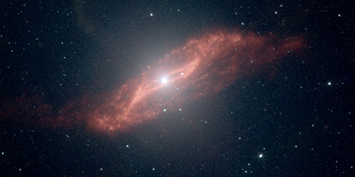 An infrared view of Centaurus A shows a red disk that's slightly tilted from on-edge, and an unusual parallelogram shape that is also red