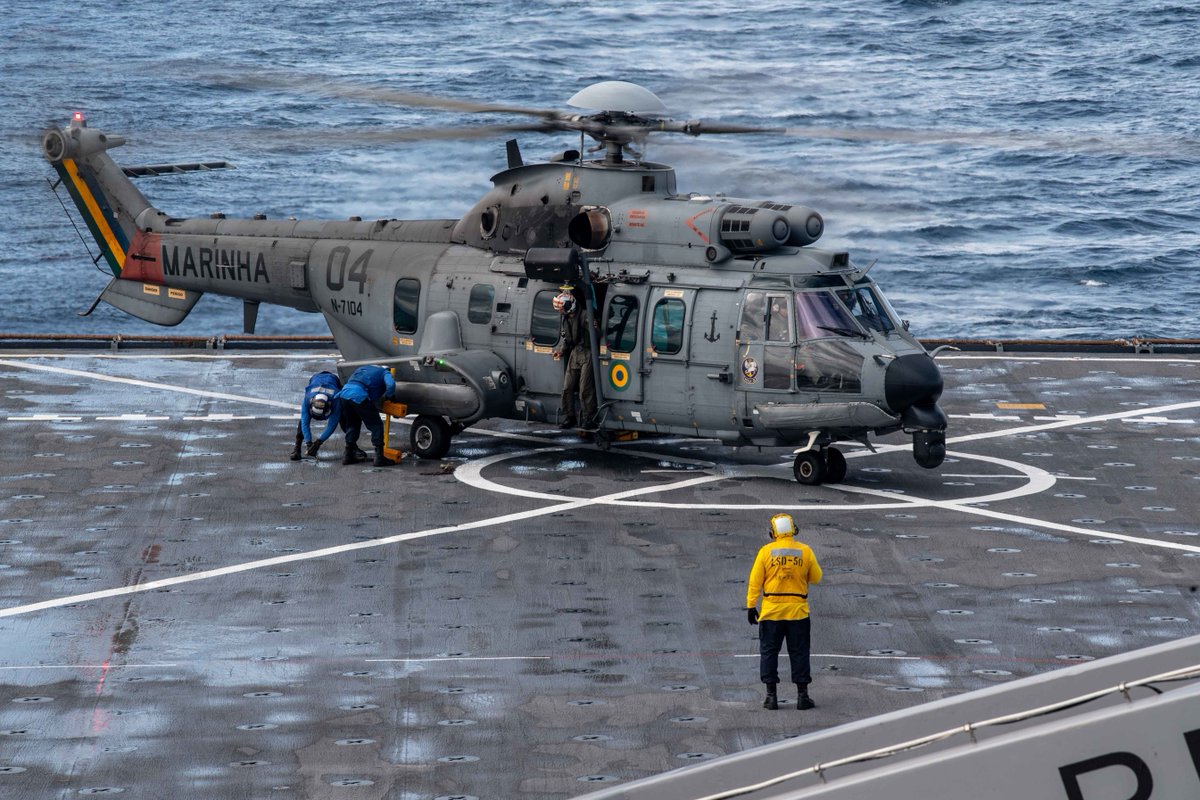 DeptofWar's tweet image. A Brazilian Navy Eurocopter EC 725 Super Cougar conducts flight operations  aboard the flight deck of th #USSCarterHall in support of  UNITAS LX (60). UNITAS, which means “unity” in Latin, has been held annually since 1960. #KnowYourMil