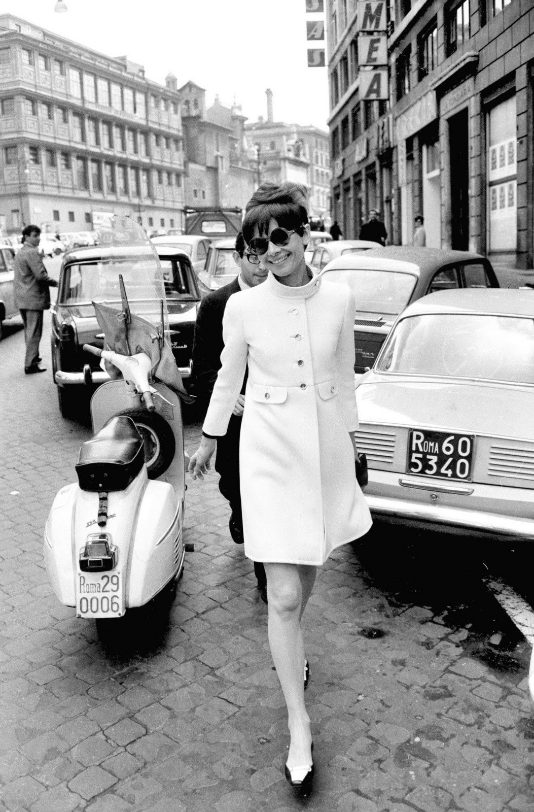 Audrey Hepburn, in a Rose Bertin coat, Gucci handbag and Roger