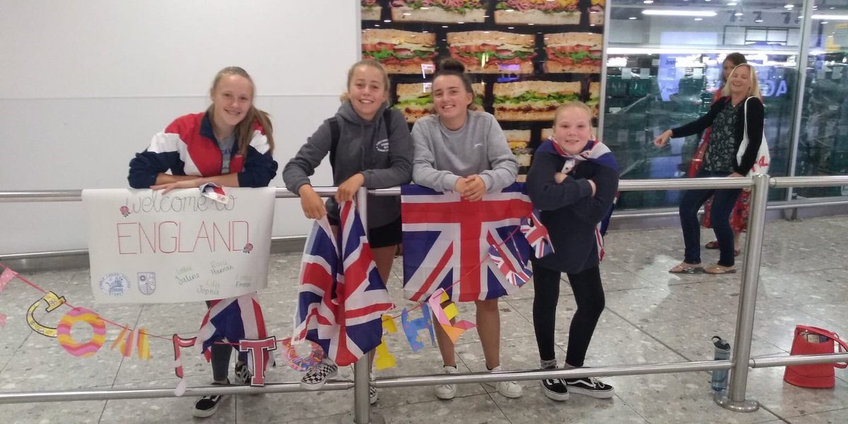 RedMaidsinOz's tweet photo. Waiting at arrivals with our banners and flags! https://t.co/kybJn8ytQZ