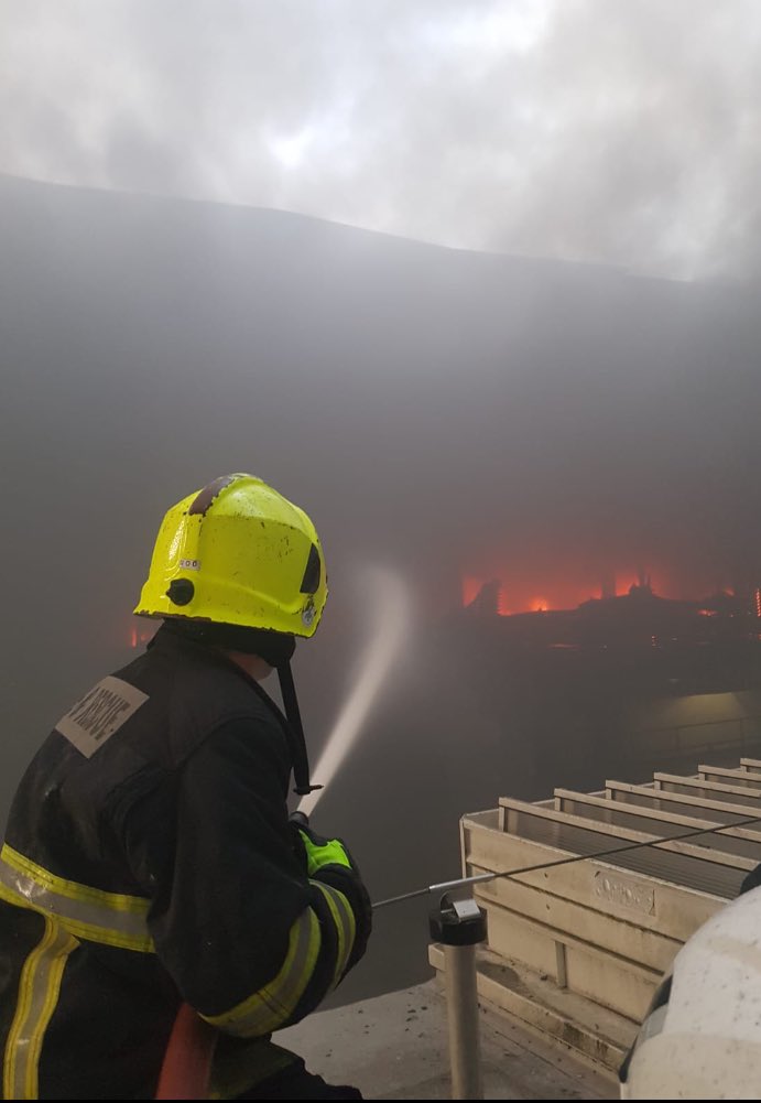 CorkCityFire's tweet photo. UPDATE: Large Fire in Douglas Shopping Centre, several units from around the city in attendance. 

Crews working very hard in heavy smoke and fire conditions to contain fire 🔥 🚒

⚠️ Please avoid the area to allow crews to access the building ⚠️
#corkfire https://t.co/F9P9Bk3zRc