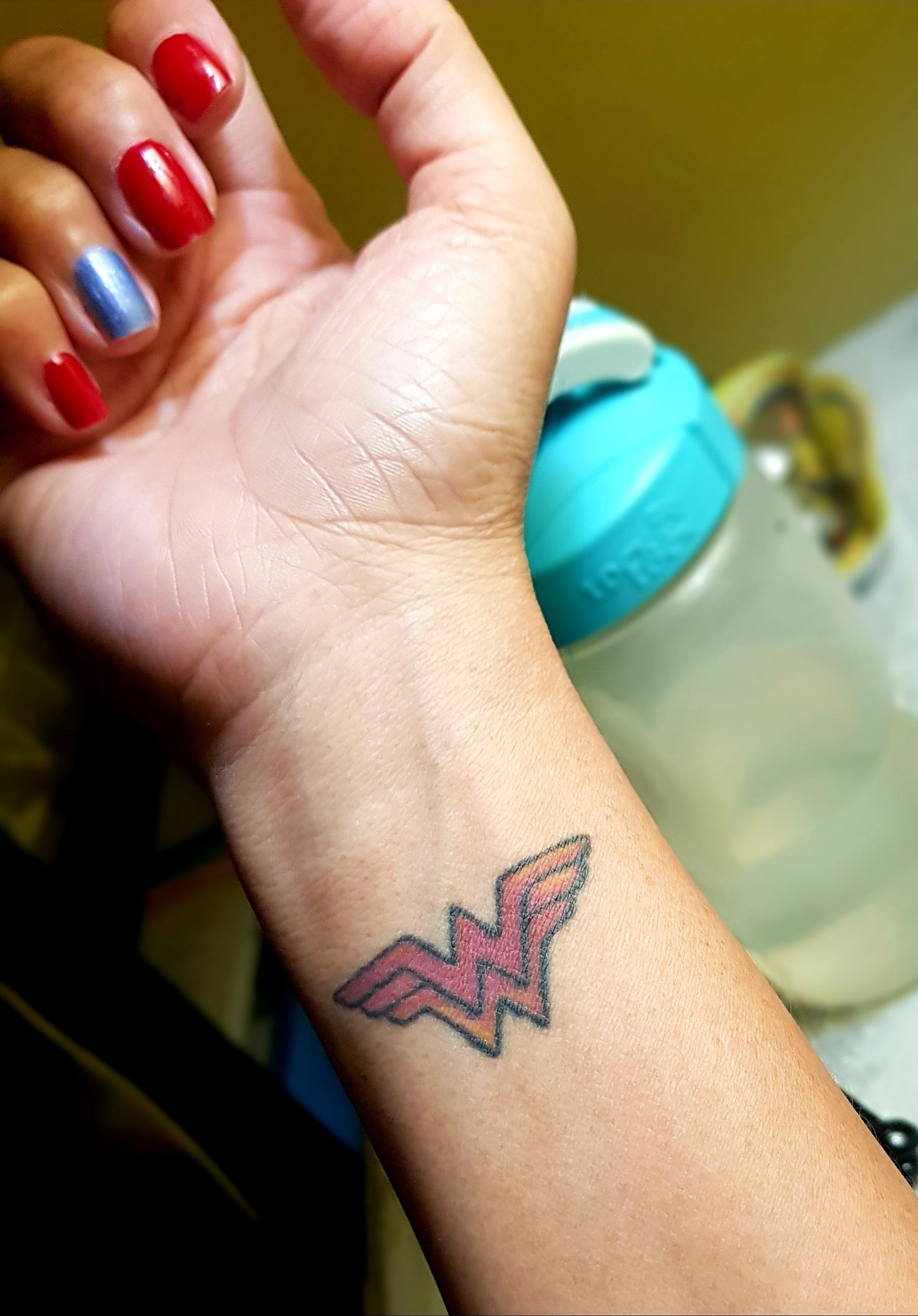 wonder woman logo wrist tattoo