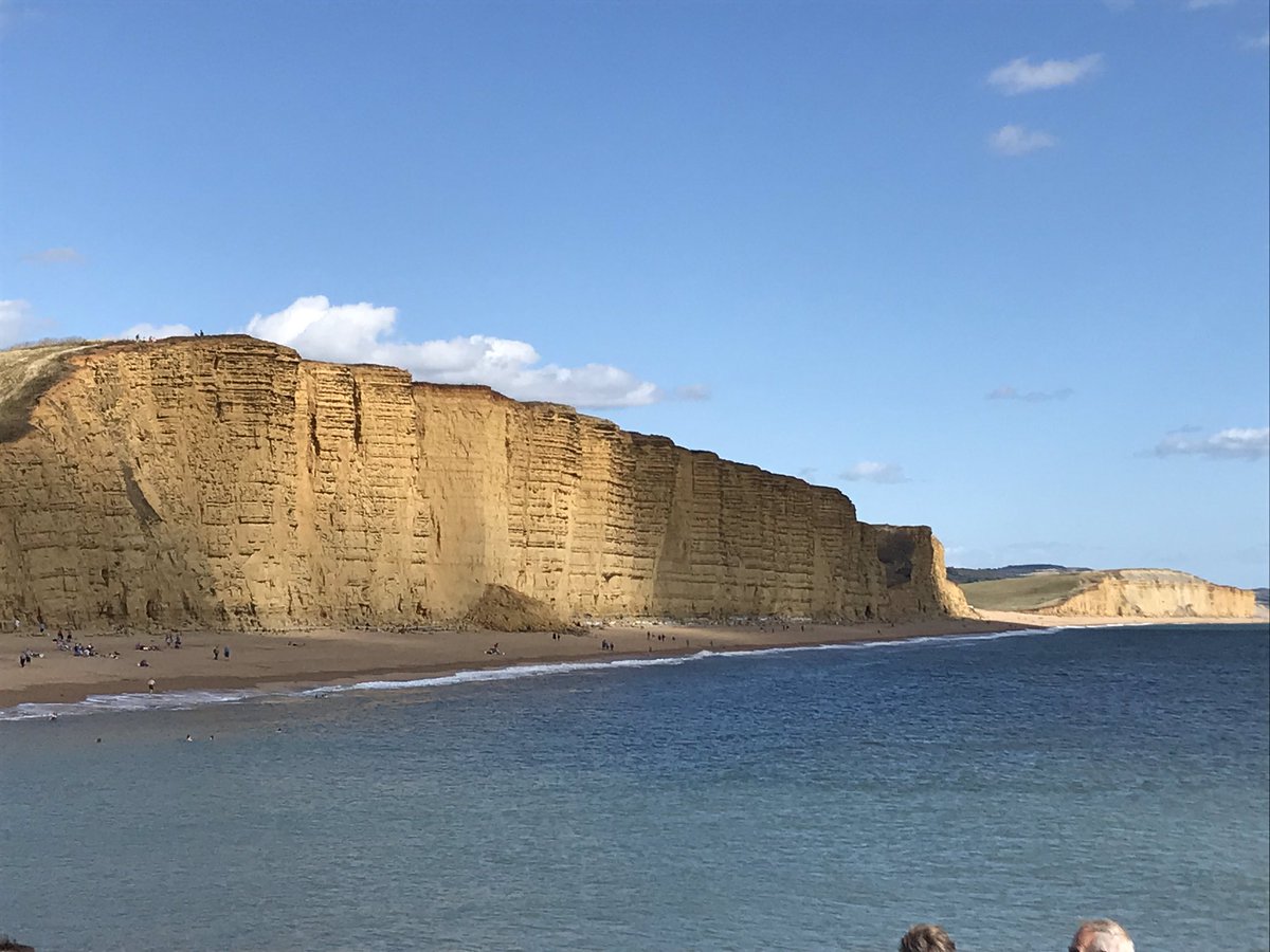 MikeAClare's tweet photo. Recent rock fall at West Bay, Dorset #masswastedsunday plus a lovely day to be on the beach - but too many people sunbathing immediately below the drop zone... https://t.co/FfQSj63IvC