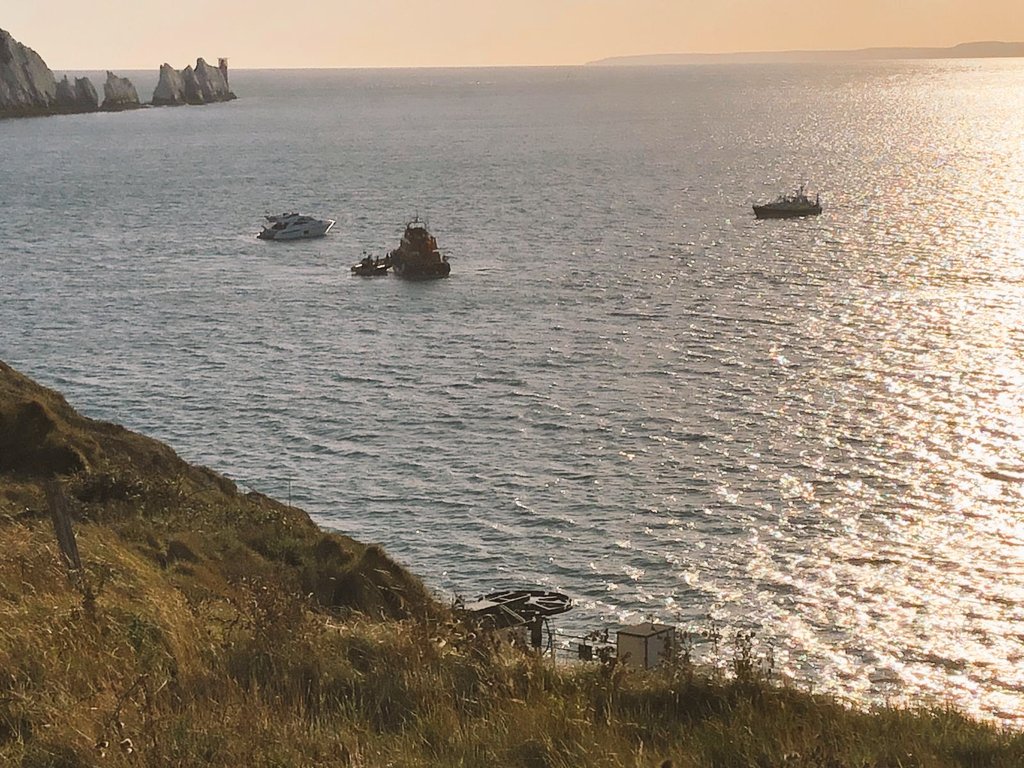 Tasked YESTERDAY at 17:54 to a sinking vessel in Alum Bay, 10 persons onboard. Reports of persons in the water. Yarmouth ALB on scene upon our arrival, all cas' accounted for and pumping of the casualty vessel under way. Once stable a tow was established and taken to Lymington.