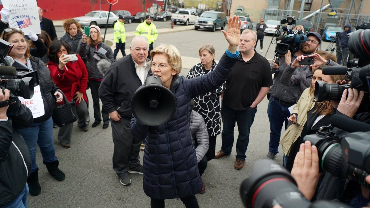 Elizabeth Warren stands with workers as they go on strike.