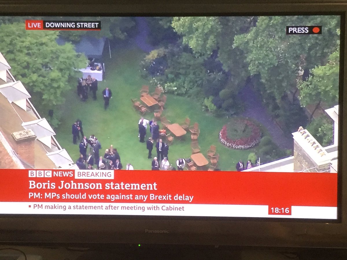 StewartWood's tweet photo. Not a great look to have a Prime Minister addressing the nation on a matter of grave national interest outside 10 Downing Street, while his party’s MPs enjoy champers &amp; canapés in the no.10 garden a few yards away. https://t.co/VymlblsWkw