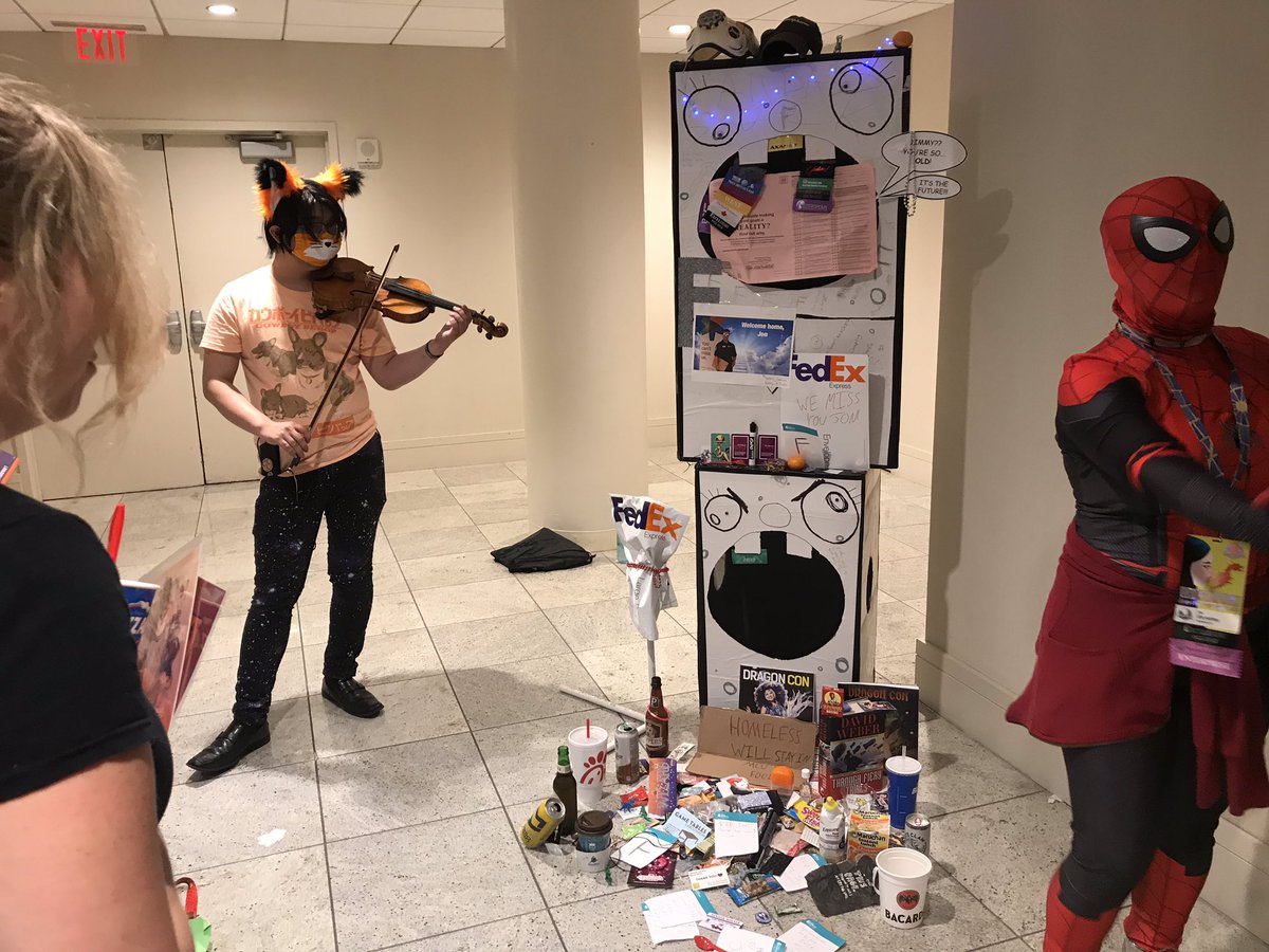 Eghfeithrean's tweet photo. They’re having a memorial for Jon the FedEx cutout guy.
“He’s gone to a place where there is no return shipping. Praise be to Jon! May he bless us with overnight shipping.”
#OnlyAtDragonCon
#DragonCon2019 https://t.co/mbJMaKdWLP