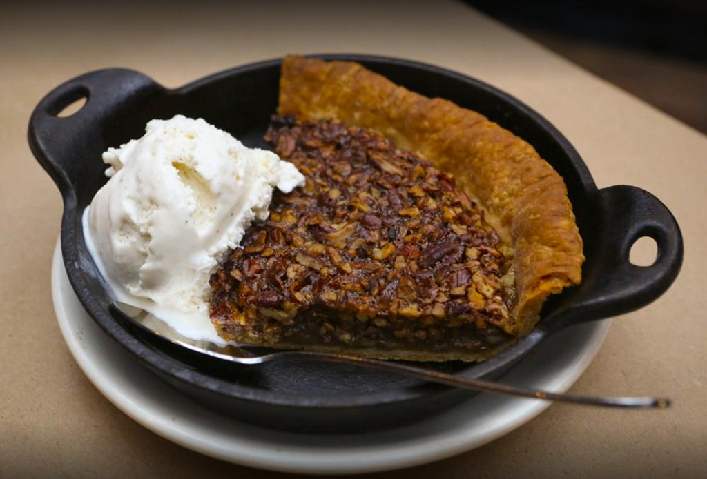 Homemade Pecan Pie with a scoop of ice cream: an authentic southern classic. We're not buying this whole "summer is over" thing #HendricksBBQ #StCharlesMO #PecanPie