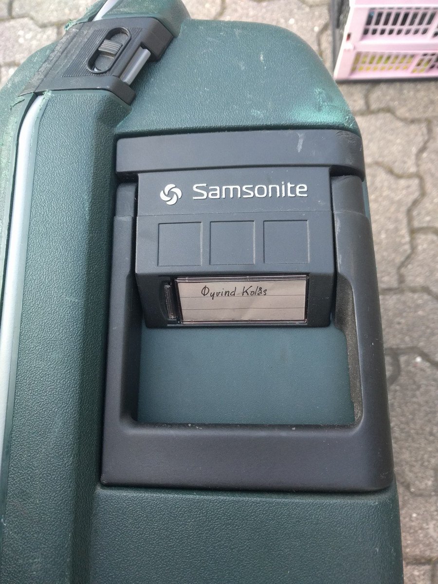 tag on a green suit samsonite case.
