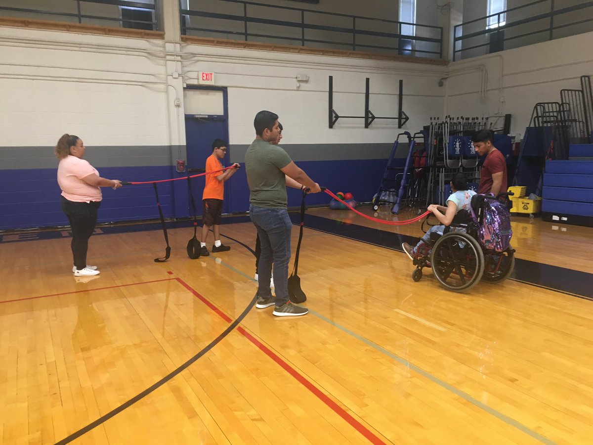Coach_KLewis's tweet photo. Our Partners and Athletes @EISDMemorialHS learning about proper warmup and muscle strengthening using resistance bands. @EISDSpecial @EISDofSA #inclusiveparticipation https://t.co/3B1Fah0fTo