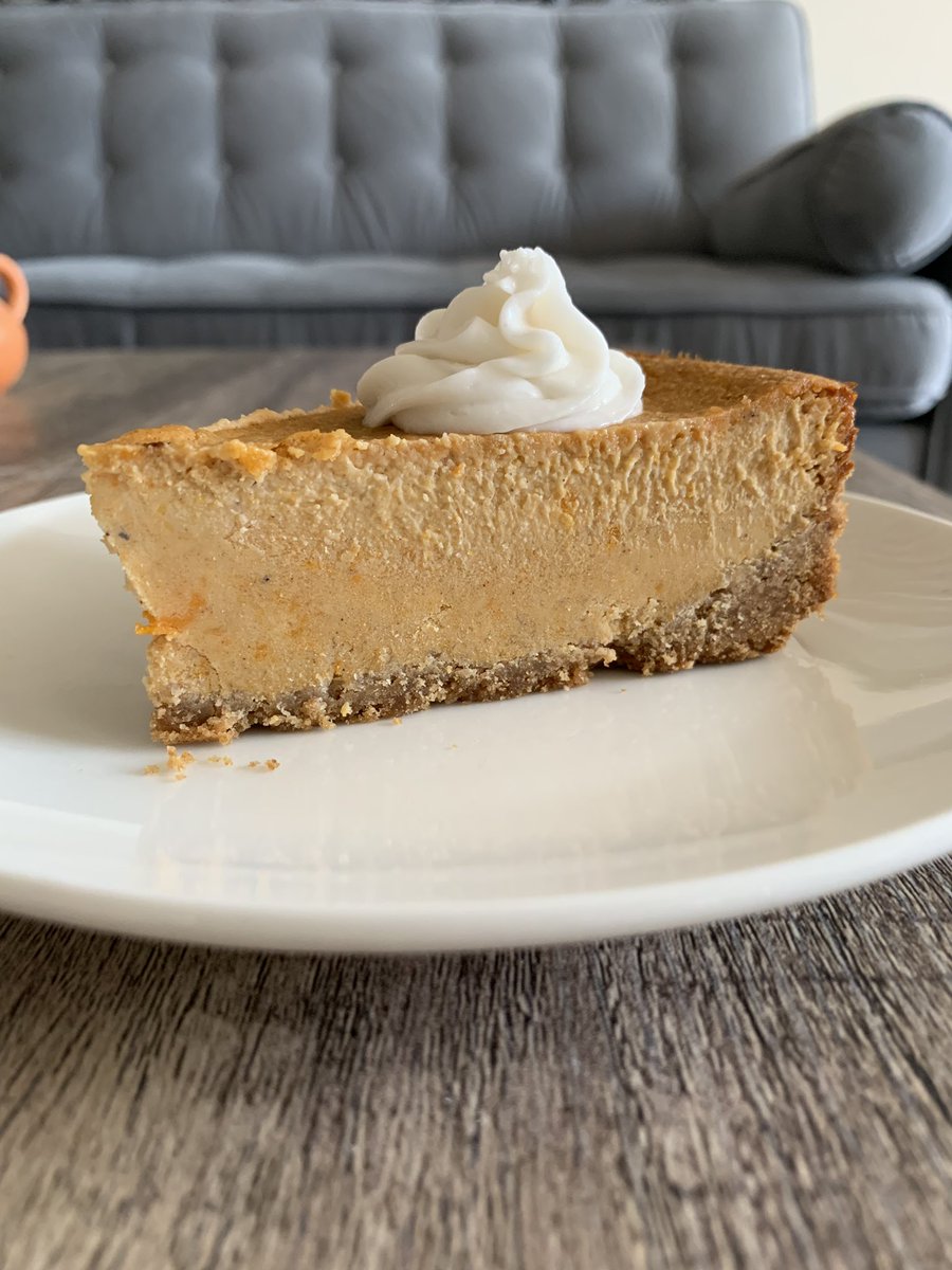 Sweet Potato cheesecake with a graham cracker crust & topped with coconut cream 