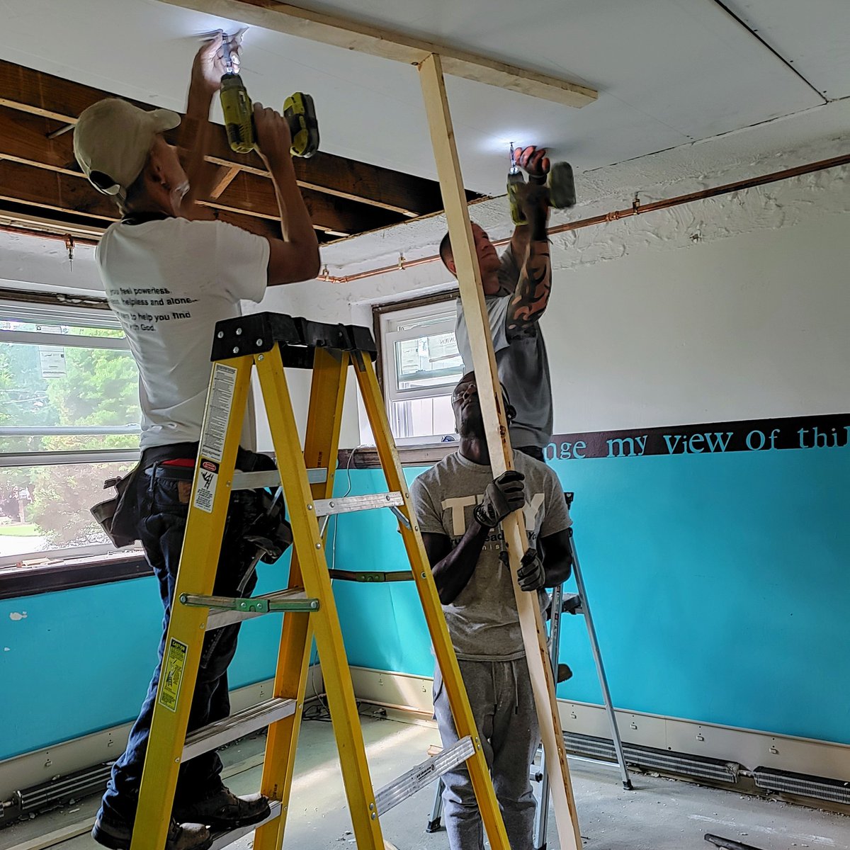 TRY_akron's tweet photo. #workingwednesday 
Our training partner, Boun (white shirt), is teaching these two guys how to  properly hang drywall. Check out the teamwork! https://t.co/V3BfhbHO89