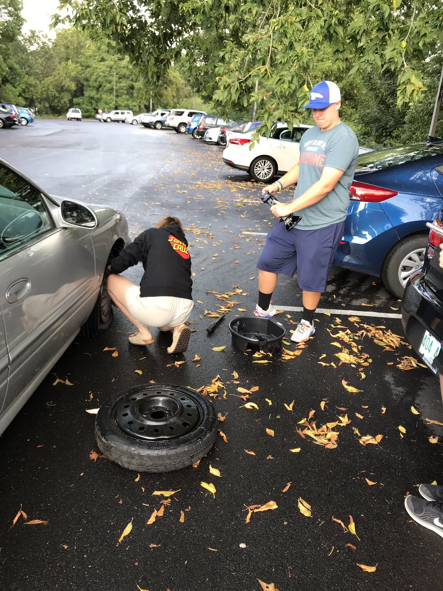 AnselmianARC's tweet photo. A visitor trying to leave campus discovered she had a flat tire. Three Anselmians didn’t hesitate to take charge and change it. https://t.co/fCtqYUib1W