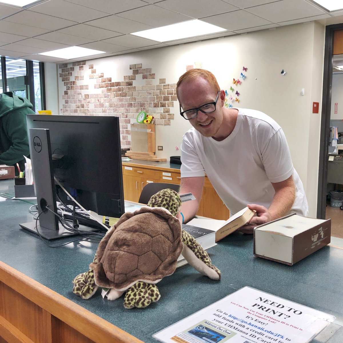 UHMLibrary's tweet photo. Whenever you're ready to check-out research materials for that first paper or project, visit our friendly Access Services staff and students at our circulation desk! Holo dropped by with a stack of books this morning! #uhmlibrary #circulationdesk #Holo https://t.co/LUP3ya9Hqn
