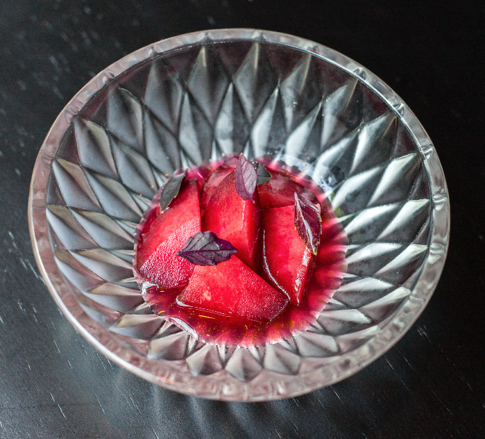 Pre-dessert | fermented Santa Rosa plum, shiso oil, opal basil from the garden. For this dish, we pair over and under ripe plums for a refreshing contrast of sweet and tart.
