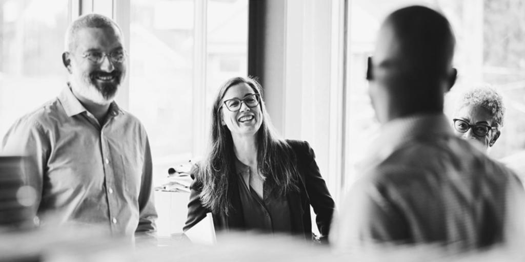workplace colleagues smiling at each other