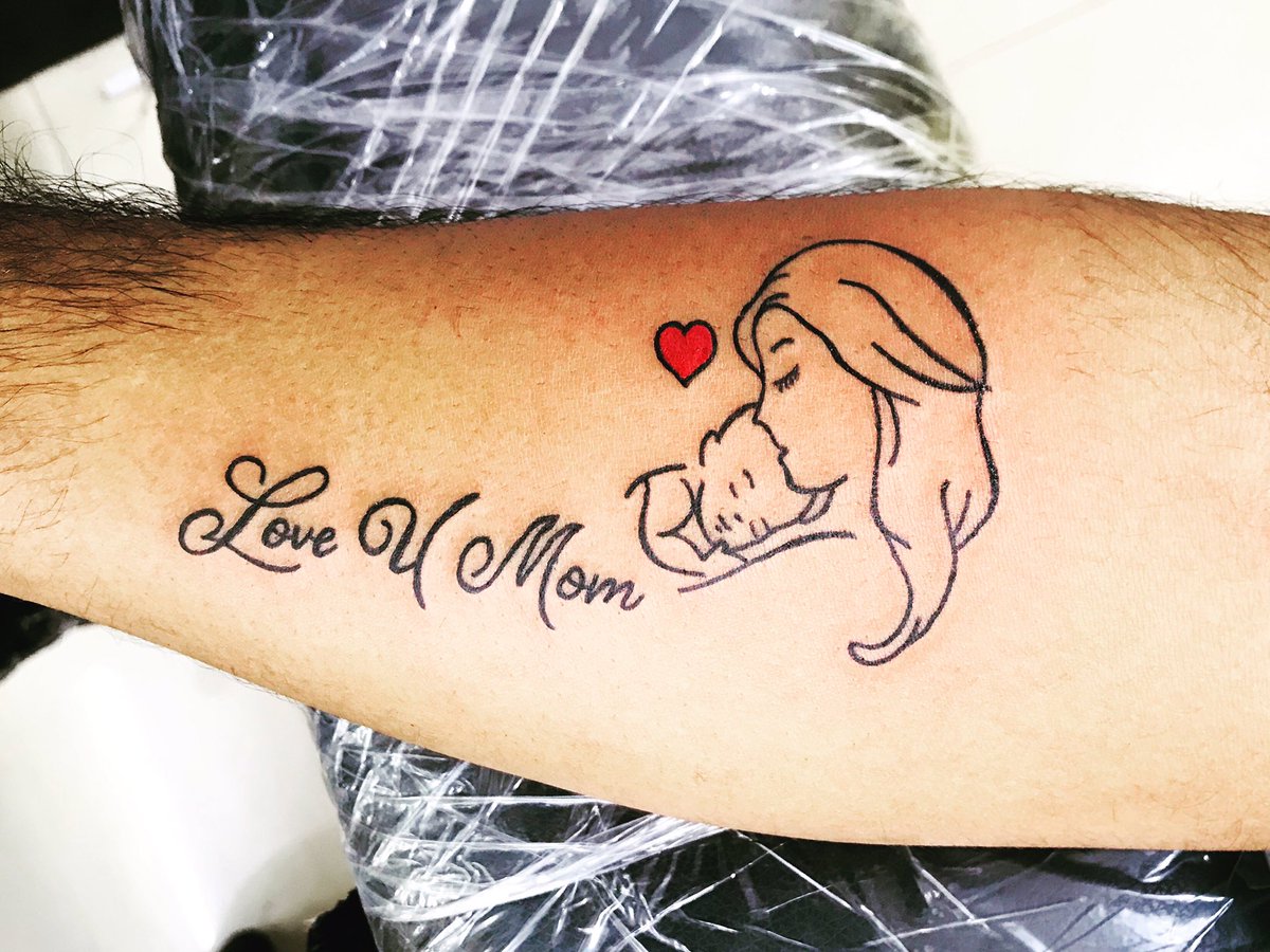 Mom Love lettering tattoo located on the wrist