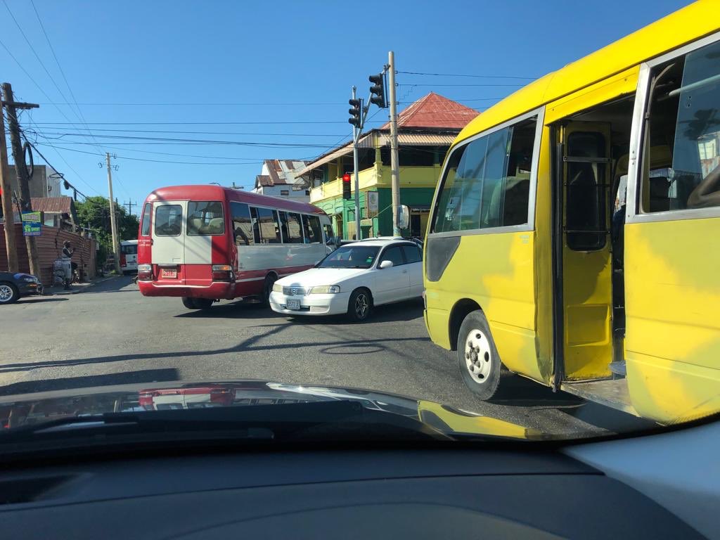 simclarkecooper's tweet photo. Left lane to be going straight down; right lane to turn right. Light is red. Bus in front decides to break light and lane rules. Obstructs oncoming motorist (white car) who has the green light. #RoadChronicles https://t.co/Gue0qcOE6k