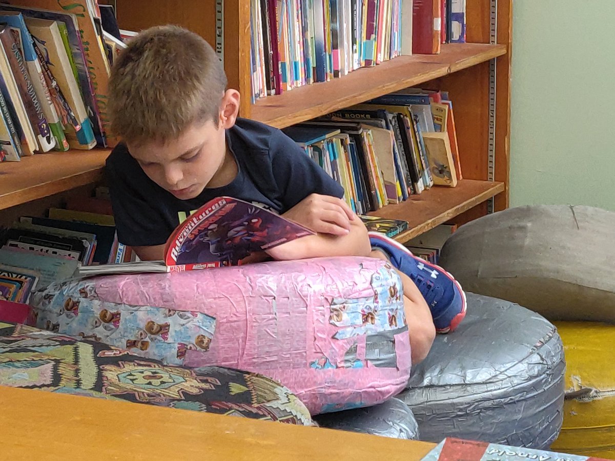 Mr_Shave_TIS's tweet photo. Even the busiest spirit settles with perfect book in a comfortable setting. My Super Sidekicks are developing reading endurance. @TitusvilleTiger @ArlingtonCSD #comics #ACSDreads #Superheroes #booksarecool https://t.co/6XbKKU8f1I