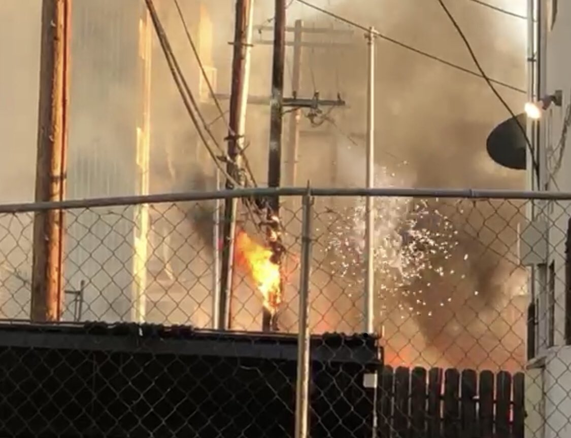 LAFDtalk's tweet photo. Sparks fly while #yourLAFD battles a structure fire. Watch out where that ladder gets placed! We navigate many different hazards during the course of our duties. #electric #LAFD #StructureFire #WiresDown #hotenoughforthecalendar https://t.co/RsR3ZrLrCr