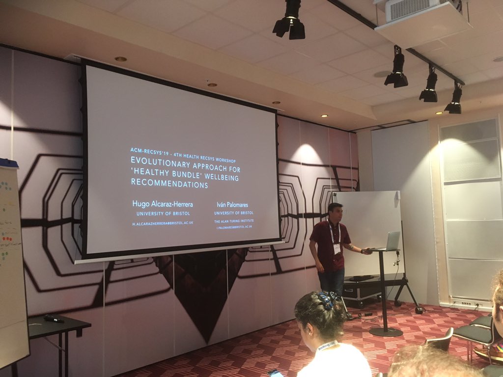 HannaHauptmann's tweet photo. Hugo Alcaraz-Herrera presenting work on "Evolutionary Approach for 'Healthy Bundle' Wellbeing Recommendations" at the #HealthRecSys workshop #recsys2019 https://t.co/poCXq8ANpL