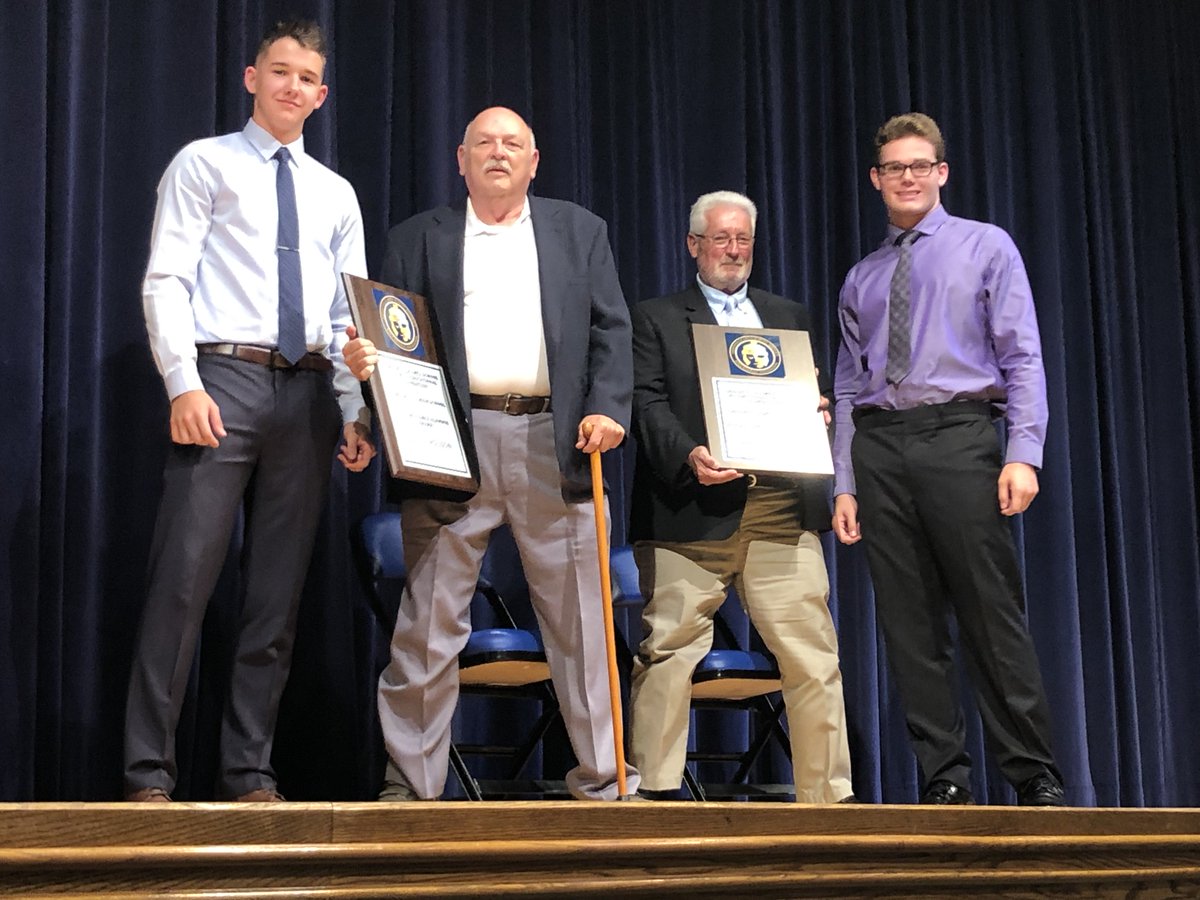 GHS seniors River Sorg and Justin Harbaugh pose with Distinguished Alumni Dave Ferguson (l) and Mike Walton (r) from the GHS Class of 1969 who were recognized during a GHS Homecoming week assembly