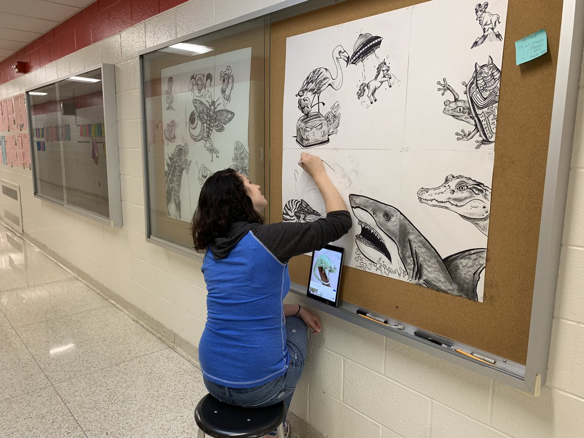 robin_doubrava's tweet photo. Intermediate School Art teachers Ms. Niforatos and Mr. Bell showcasing  our fabulous art program by completing hallway display case drawings as students arrive in the morning.  Their drawings are based on student suggestions!  #ISinnovators  #ExploreEmpowerExcel https://t.co/wq13p99cM6