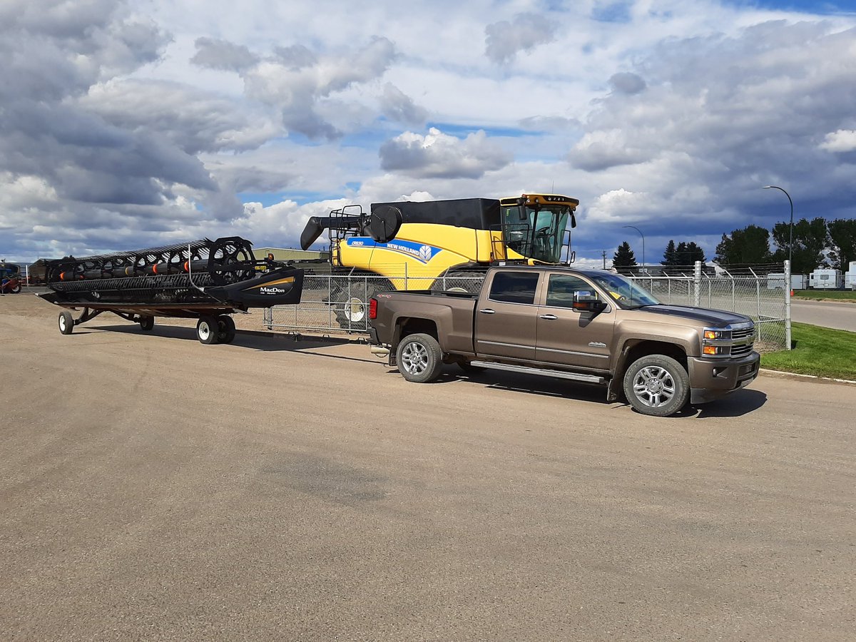 wheatiepete's tweet photo. And so the journey from Lethbridge back home to Red Deer begins. #yellowcombines #macdonheaders https://t.co/74idnl67Rr