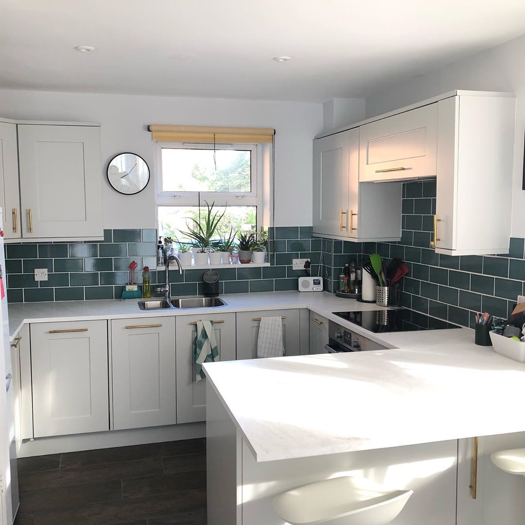 #MISTRALHighlights - Efficiency is key to this kitchen as each inch of space is utilised to create a layout that is every bit as practical as it is beautiful. MISTRAL Aria worksurfaces feature alongside stylish teal tiles and intricate shaker cabinetry, finished with gold handles