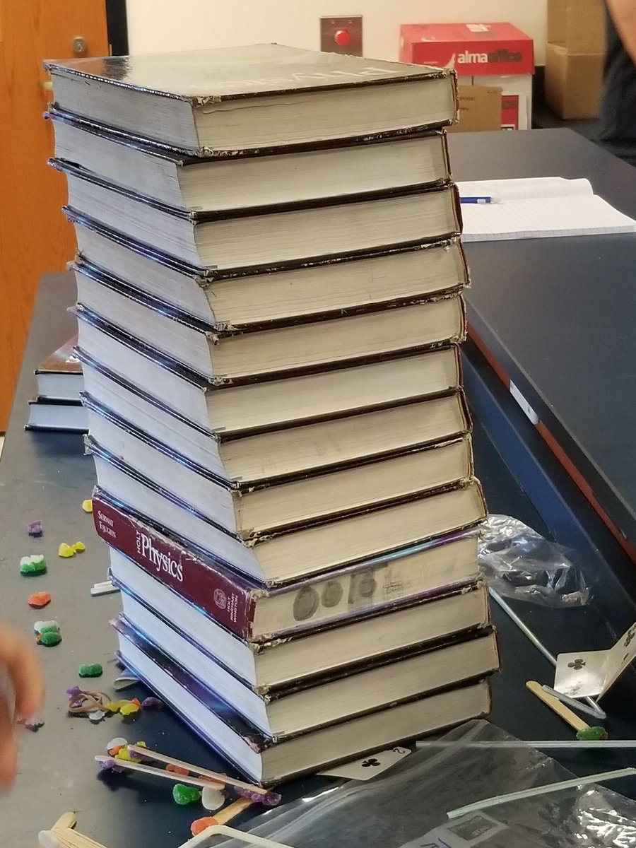 GKovscek's tweet photo. Students built a book support  for honors physics. One team had a good idea, another team pilfered the idea and added to it and stacked 12 books before it collapsed with 13 #uppingOurGame #ThisIsBASD #BHSPHYSICS https://t.co/chGkJdTHDD