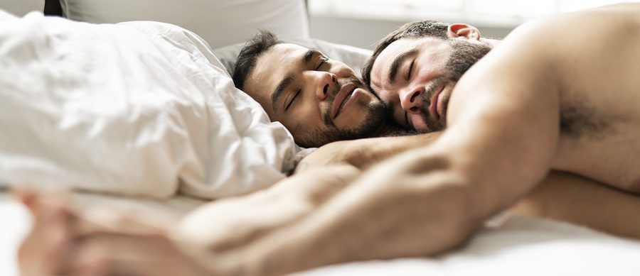 Gay couple waking up in the bed high