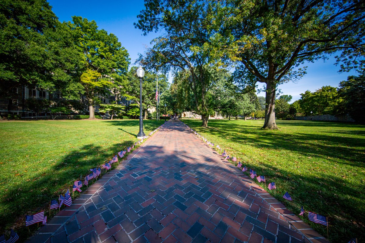 Georgetown's tweet photo. Today, American flags line the walkways of campus, a tradition that is coordinated by the College Democrats and Republicans. Together, we honor and remember those who lost their lives on September 11 and in the years since. #NeverForget https://t.co/DyUPvAr8MF