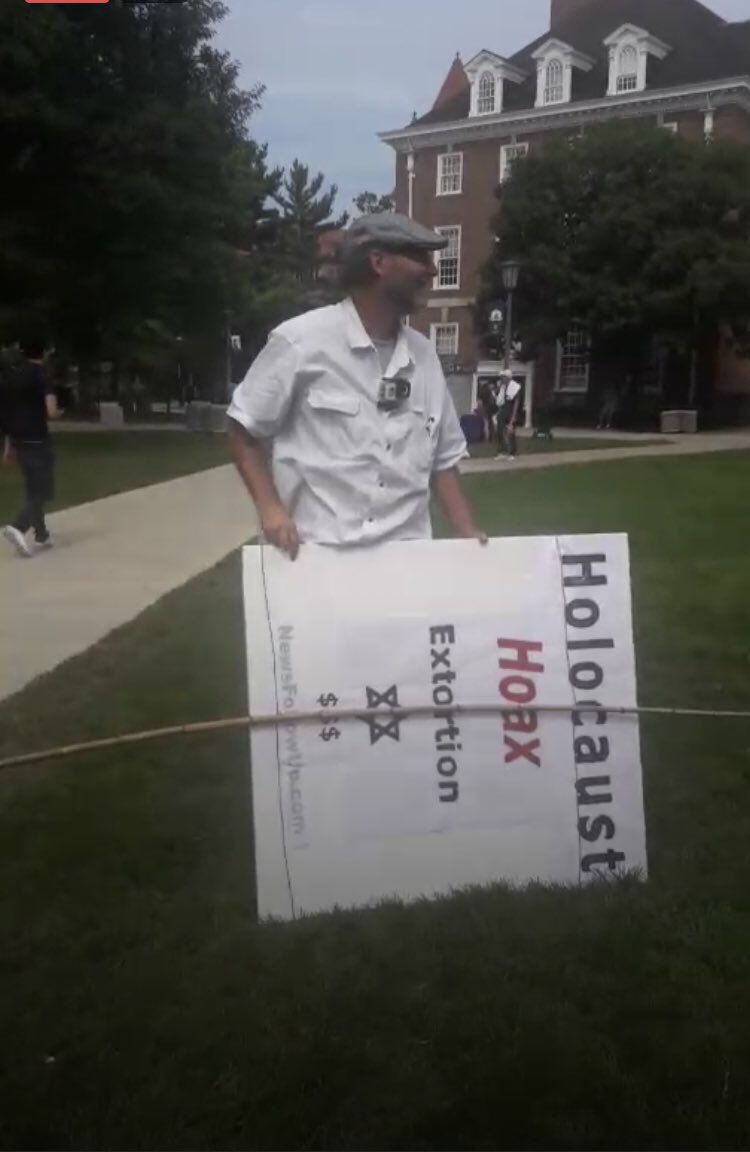 CASMovement's tweet photo. A nazi, Stephen Francis has shown up for two days in a row with shitty fascist signs at the University of Illinois Urbana Champaign, #UIUC 

Students successfully shut him down yesterday by not letting speak, not debating him and covering his sign with signs condemning racism... https://t.co/xyo1jQqB2i