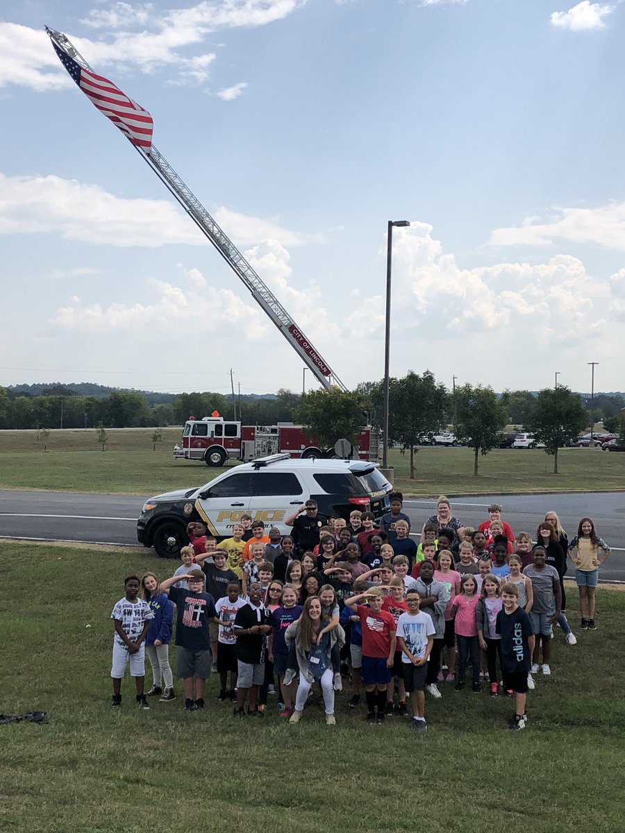 toshamac101's tweet photo. Remembering 9/11!  #Tripod.              Ss discuss events that took place on 9/11 eighteen years ago. Special shoutout to Officer Trey for getting the flag to fly for our picture.  #LETSGOTREY @TCBOE_LES @kelsiehughes23 @therealmsbyers https://t.co/DJUiixlGEV
