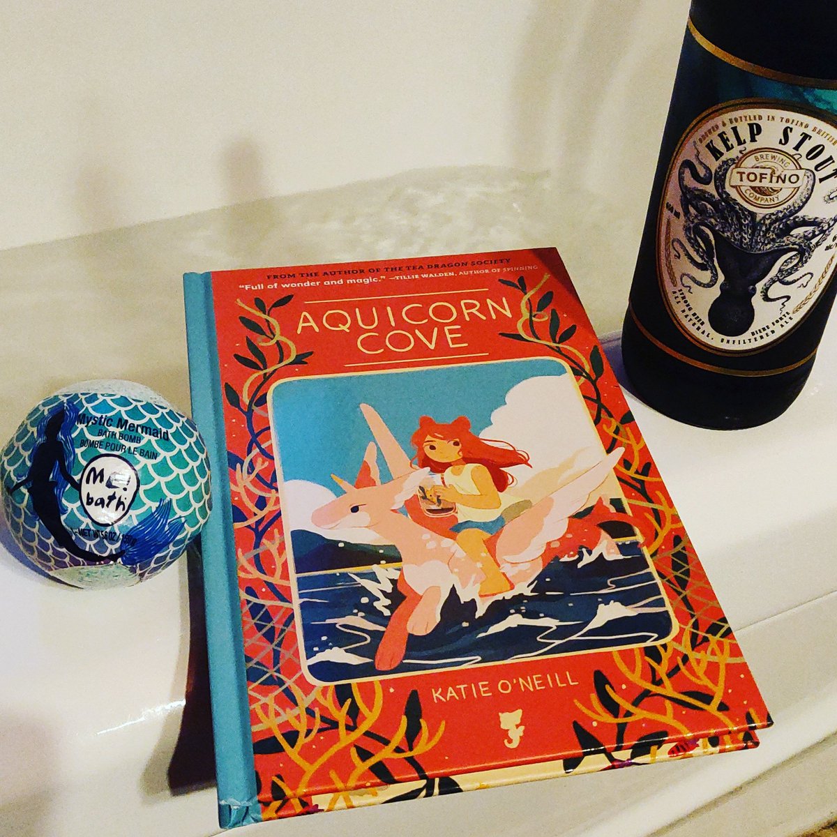 kathytrithardt's tweet photo. This week's #wednesdaytradition features Aquicorn Cove by @strangelykatie (thanks again to @JeansThoughts for this sweet book), a Mystic Mermaid bath bomb by Me Bath, and a Kelp Stout by @TofinoBrewCo. #bookbathandbeverage #treatyoself #booksandbaths https://t.co/Tr4GwOMkEE