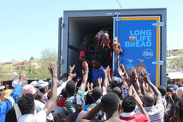 Photo of the day | BREAD OF LIFE ... Windhoek residents were yesterday treated to free loaves of bread by Namib Mills. The company dished out the bread from a truck that drove around as part of a promotion supporting local manufacturing. Photo: Henry van Rooi