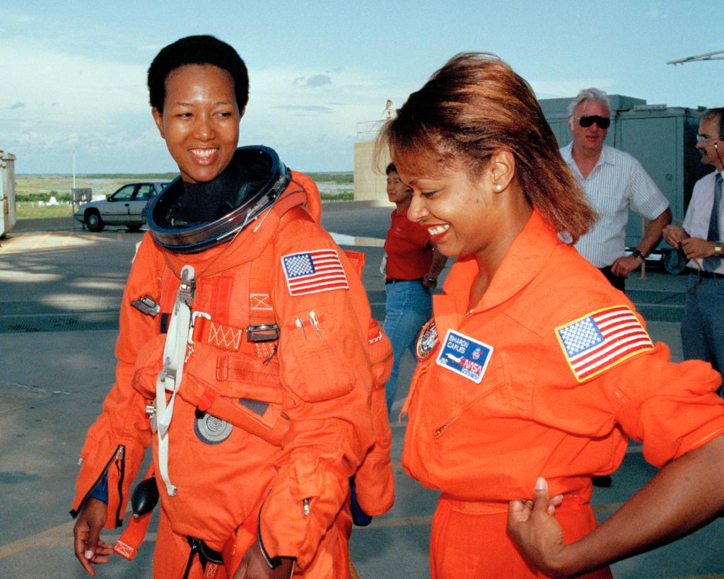 WomenNASA's tweet photo. #TBT: On this day 27 yrs ago, Mae Jemison became the 1st black woman in space when she launched aboard Space Shuttle Endeavour! In this image, she leaves training w/ Sharon McDougle, Spacesuit Technician. Remember those who broke barriers for #WomeninSTEM: https://t.co/5PjKDOhoOo https://t.co/ff4pmJ7Byl