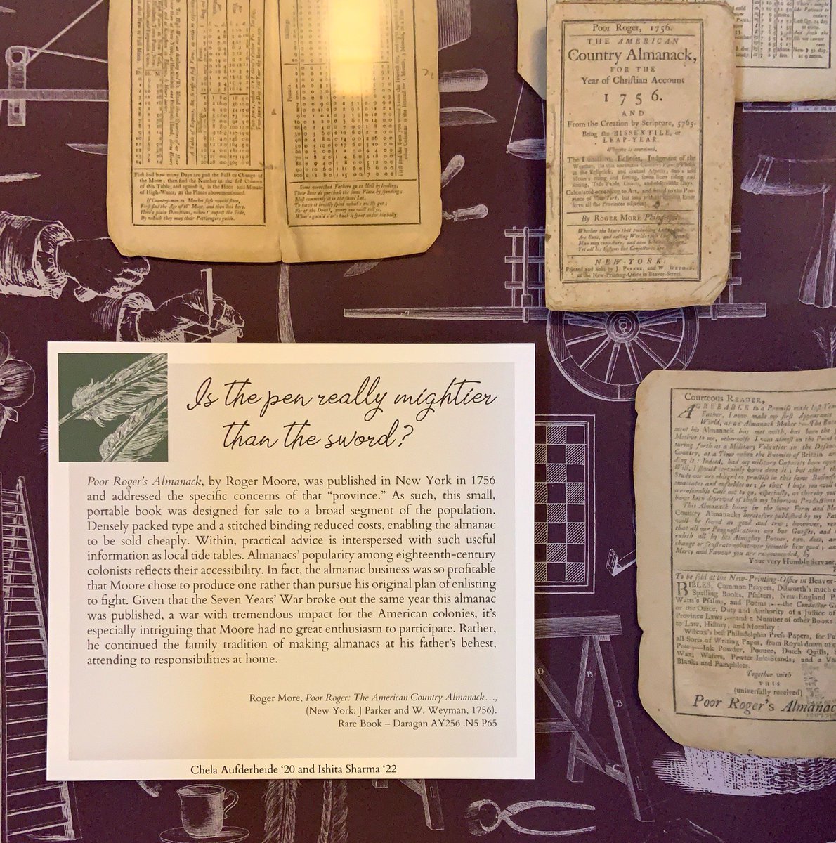 An exhibit panel titled, "Is the pen really mightier than the sword?" The panel discusses the profitability of almanacs, which were not too expensive to print. On a purple background with white outline illustrations.