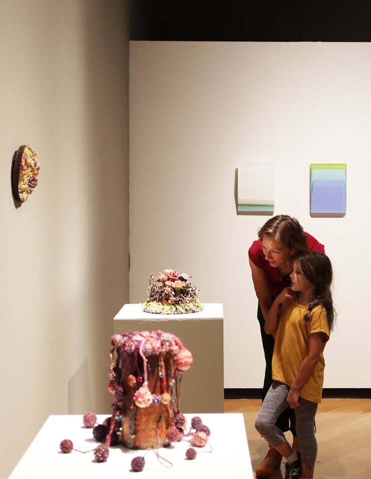 Visitors engage with Sara Dochow's works on display in "The Adjacent Possible."

Works on display from left to right : SARA DOCHOW | American, born 1952 | Overflowing, 2019; To Plant a Garden Is To Believe In Tomorrow, 2018; Garden of Delights, 2018 | Work courtesy of the Artist