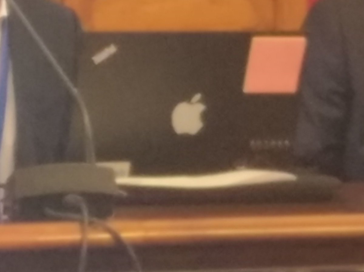 Black notebook with white apple logo and thinkpad logo