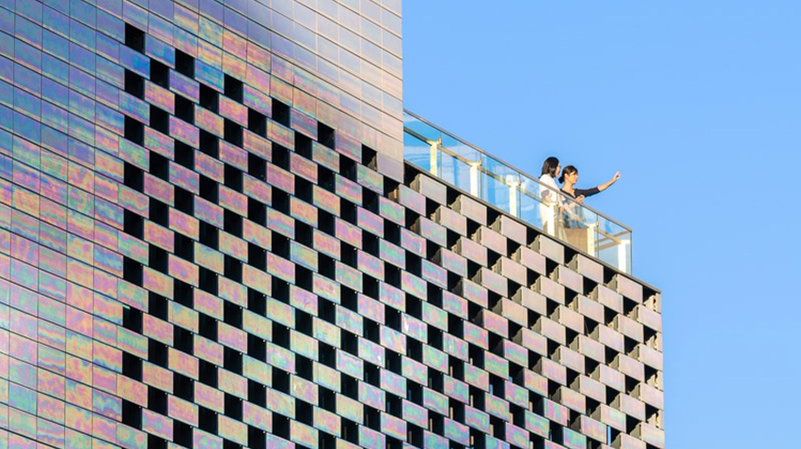 dezeen's tweet photo. This shopping centre by MVRDV is covered in shimmering ceramic tiles: https://t.co/xEnGS2rd7T https://t.co/C64fRbzEYz